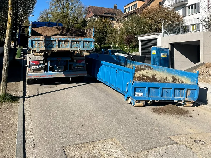Abrollmulde wird auf einer engen Quartierstrasse abgeladen