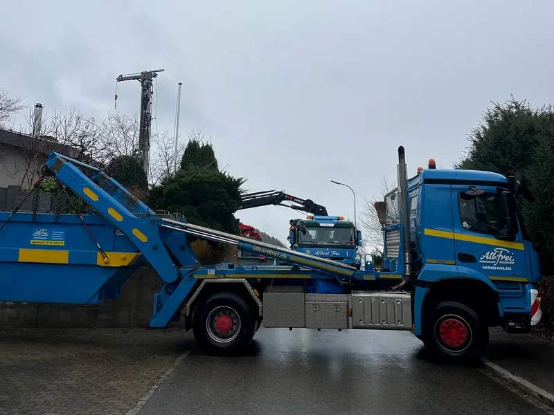 Muldenwagen setzt eine Welaki-Mulde in einer Wohnstrasse ab
